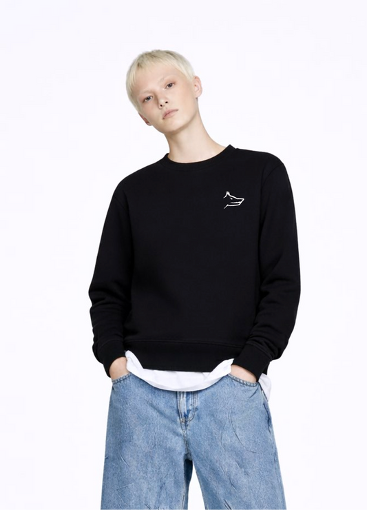 blond, short hair woman wearing a black Northwind Crossword sweatshirt with Northwind wolf embroidered logo on the chest, white shirt, blue jeans, white Northwind t-shirt under the sweatshirt
