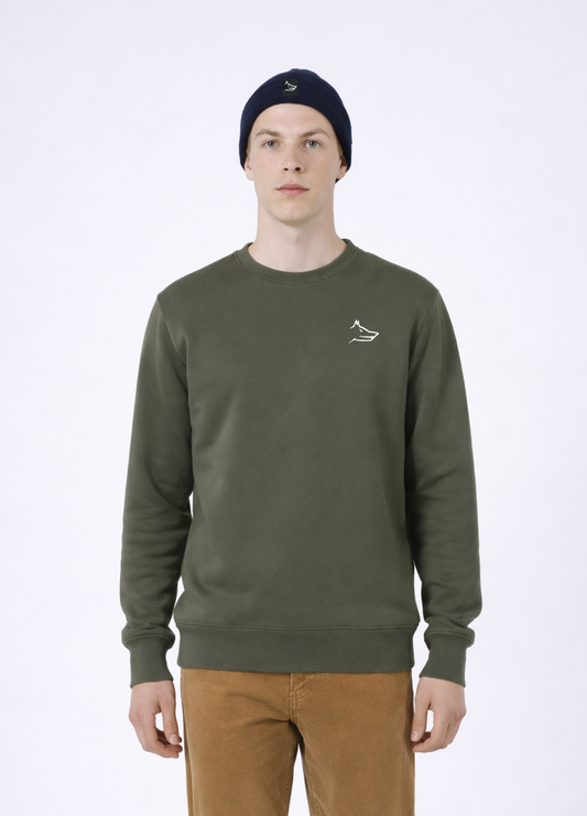 Man wearing a khaki green Northwind sweatshirt with white embroidered wolf logo of Northwind on the chest