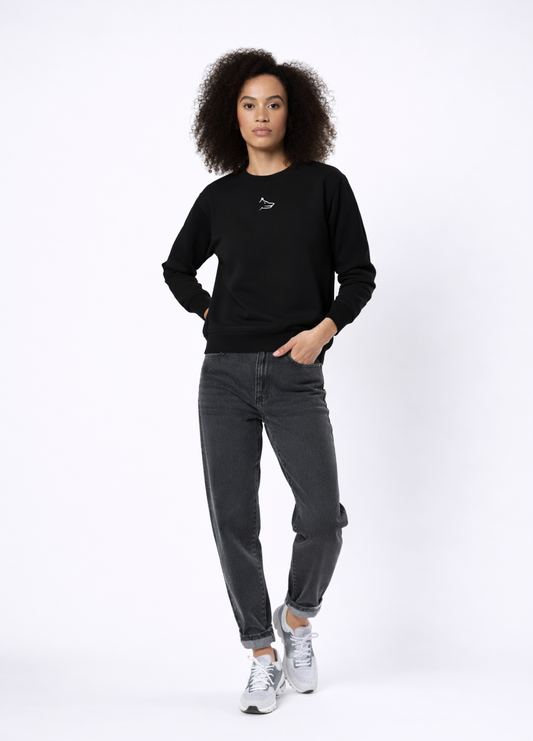 Woman wearing Northwind Lone Wolf black sweatshirt with wolf logo embroidered on the chest, gray levis jean and New Balance shoes