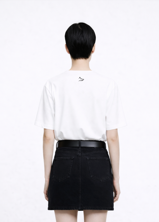 Woman wearing a white Northwind casual t-shirt with minimalist Northwind embroidered wolf logo at the back and black skirt on a white background