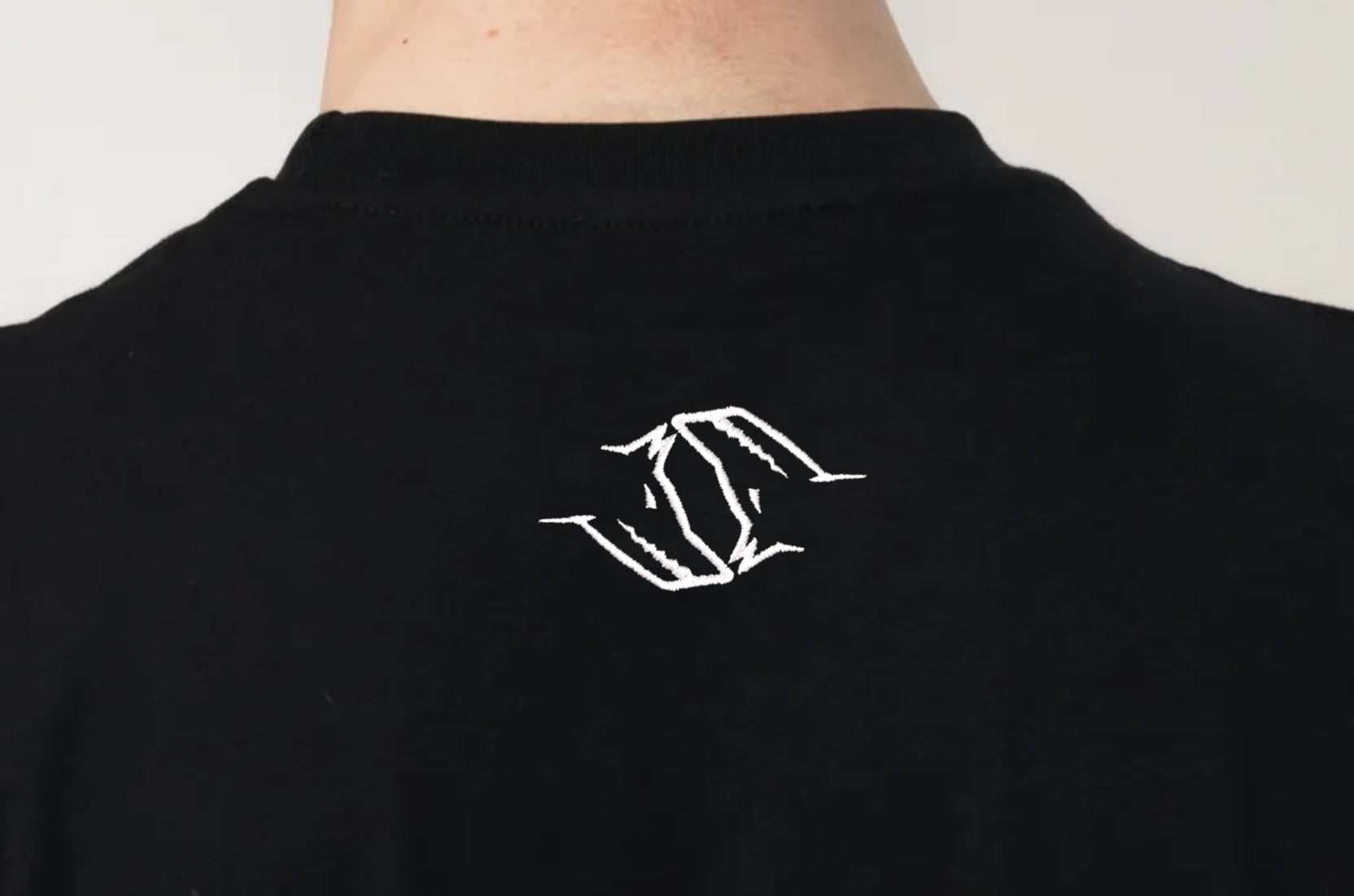 Black t-shirt with a white Northwind Wolfinity logo on the back