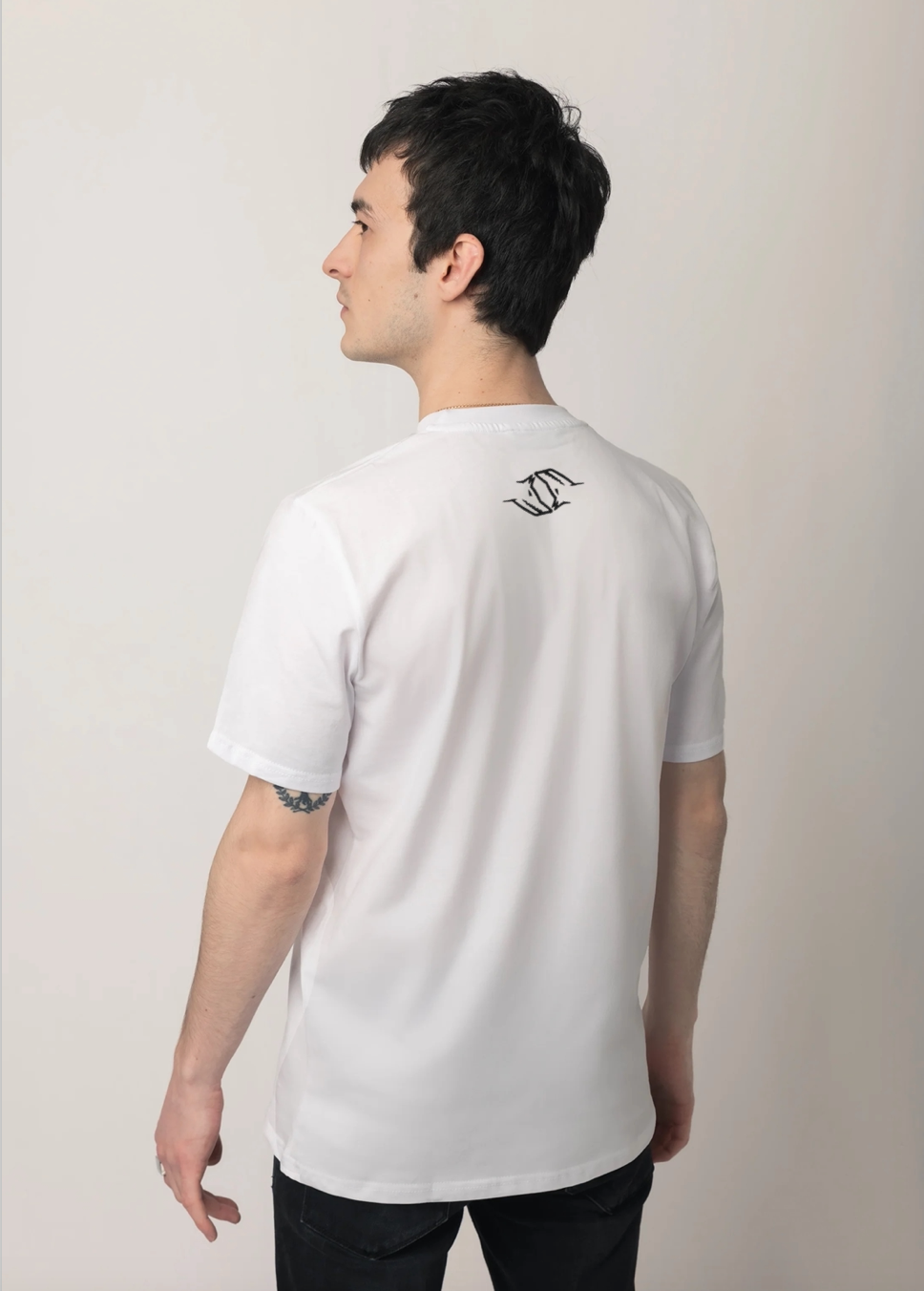 Person wearing a white Northwind Wolfinity casual cotton t-shirt with Northwind logo on the back