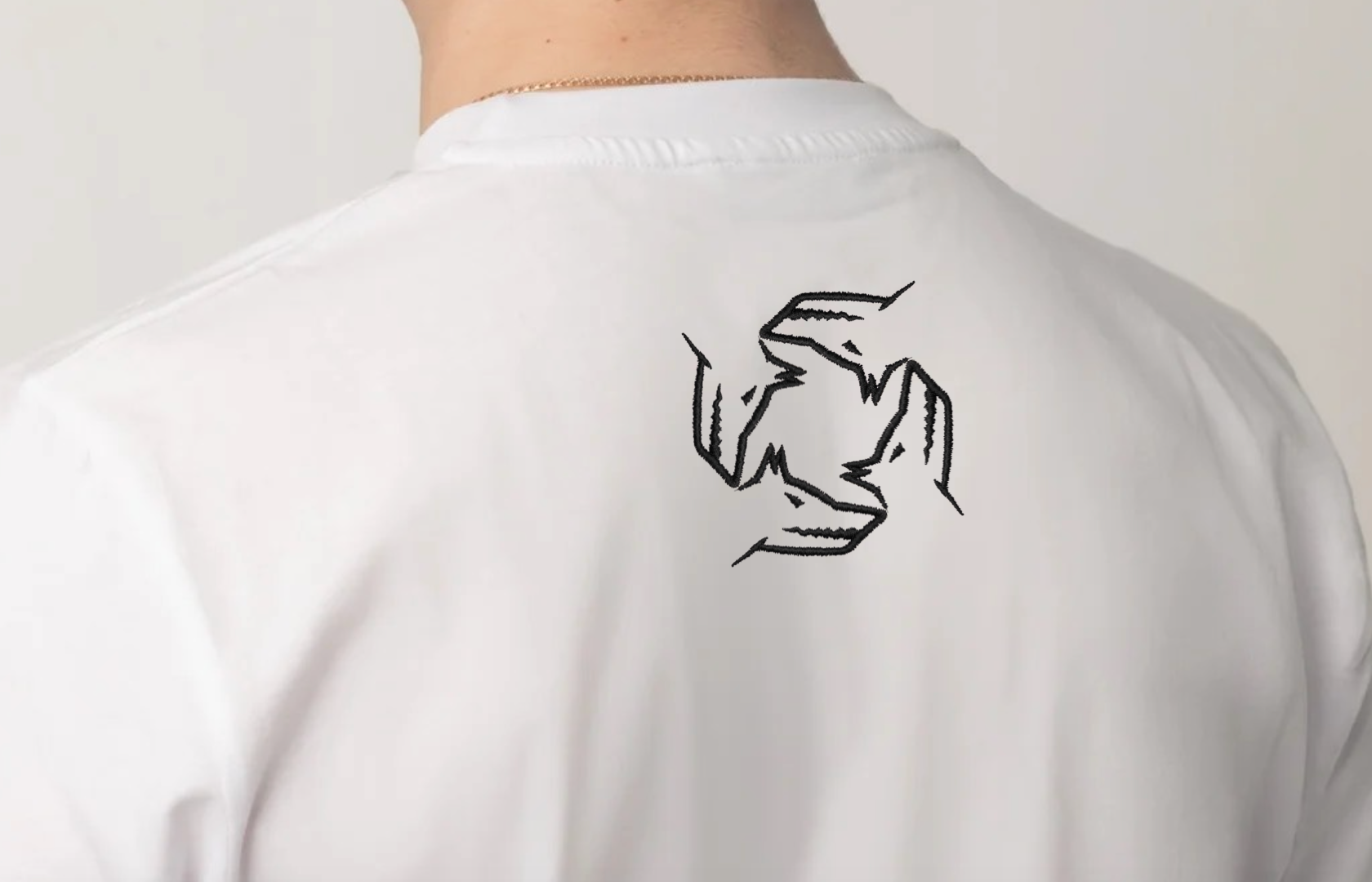 White shirt with a black Northwind storm of wolves logo on the back against a plain background