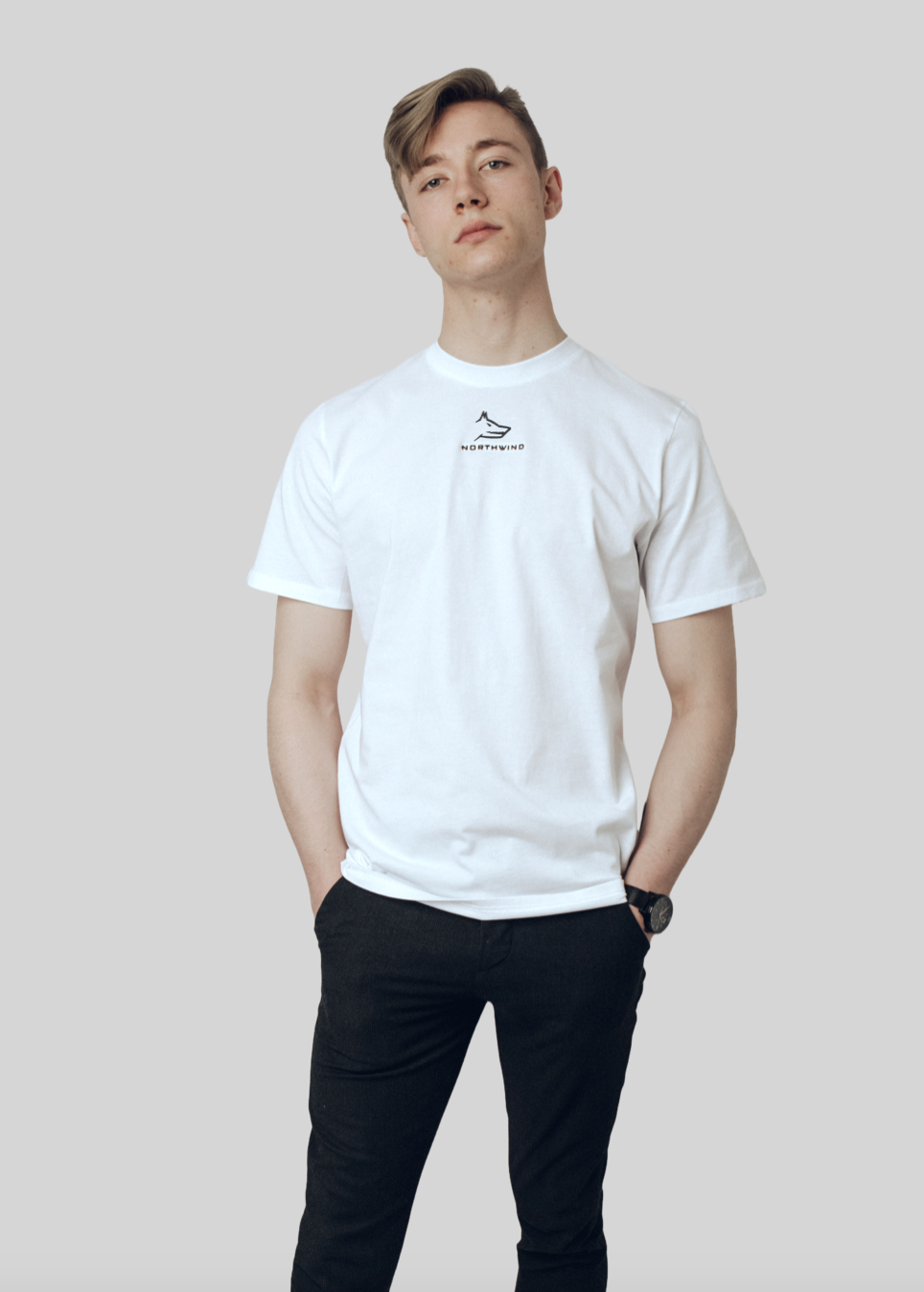 Person wearing a white Northwind casual t-shirt with a logo on a plain background