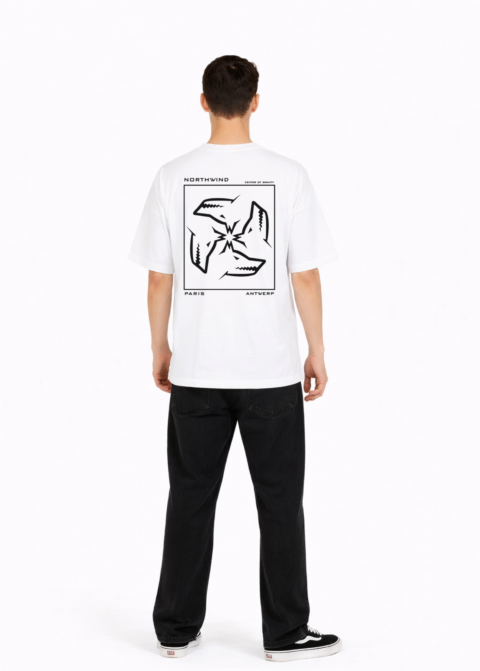 Young adult wearing a Northwind oversized organic cotton white t-shirt with Northwind embroidered on the chest, center of gravity design screen printed on the back, Carhartt pants, black Vans shoes