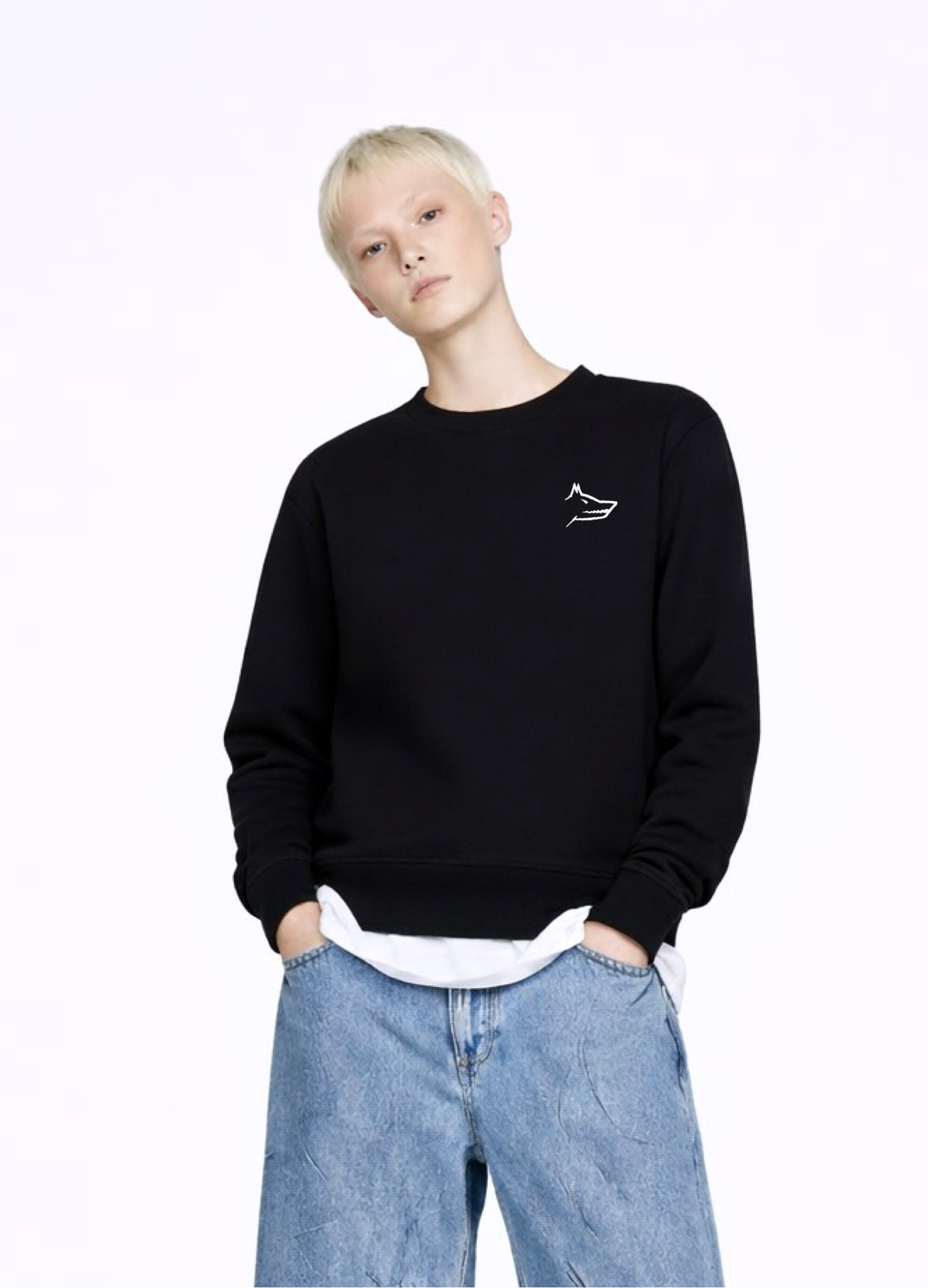blond, short hair woman wearing a black Northwind Crossword sweatshirt with Northwind wolf embroidered logo on the chest, white shirt, blue jeans, white Northwind t-shirt under the sweatshirt