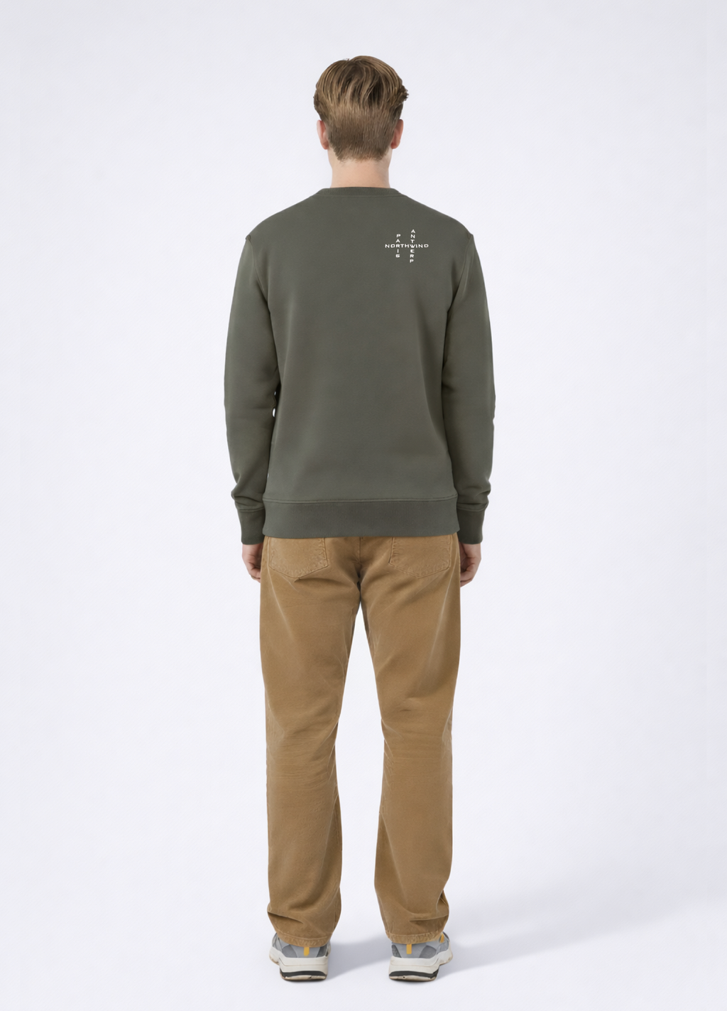 Man wearing a khaki green Northwind sweatshirt with white embroidered Northwind crossword Antwerp Paris logo on the back