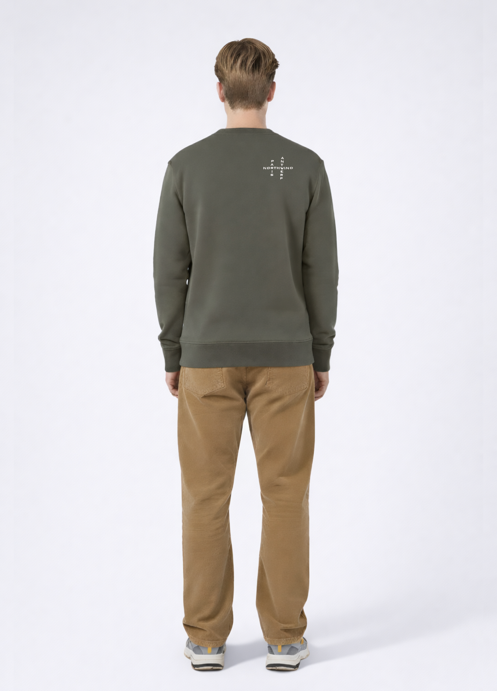 Man wearing a khaki green Northwind sweatshirt with white embroidered Northwind crossword Antwerp Paris logo on the back