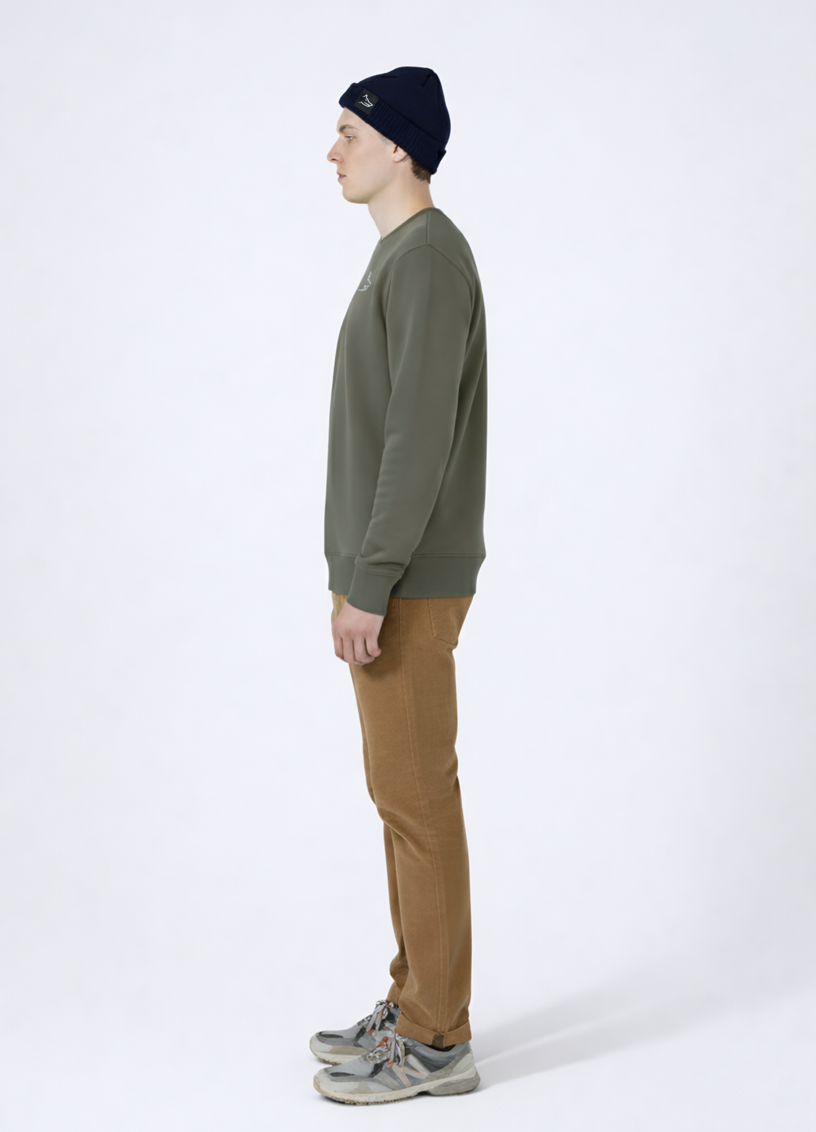 Man wearing a khaki green Northwind sweatshirt with white embroidered wolf logo of Northwind on the chest