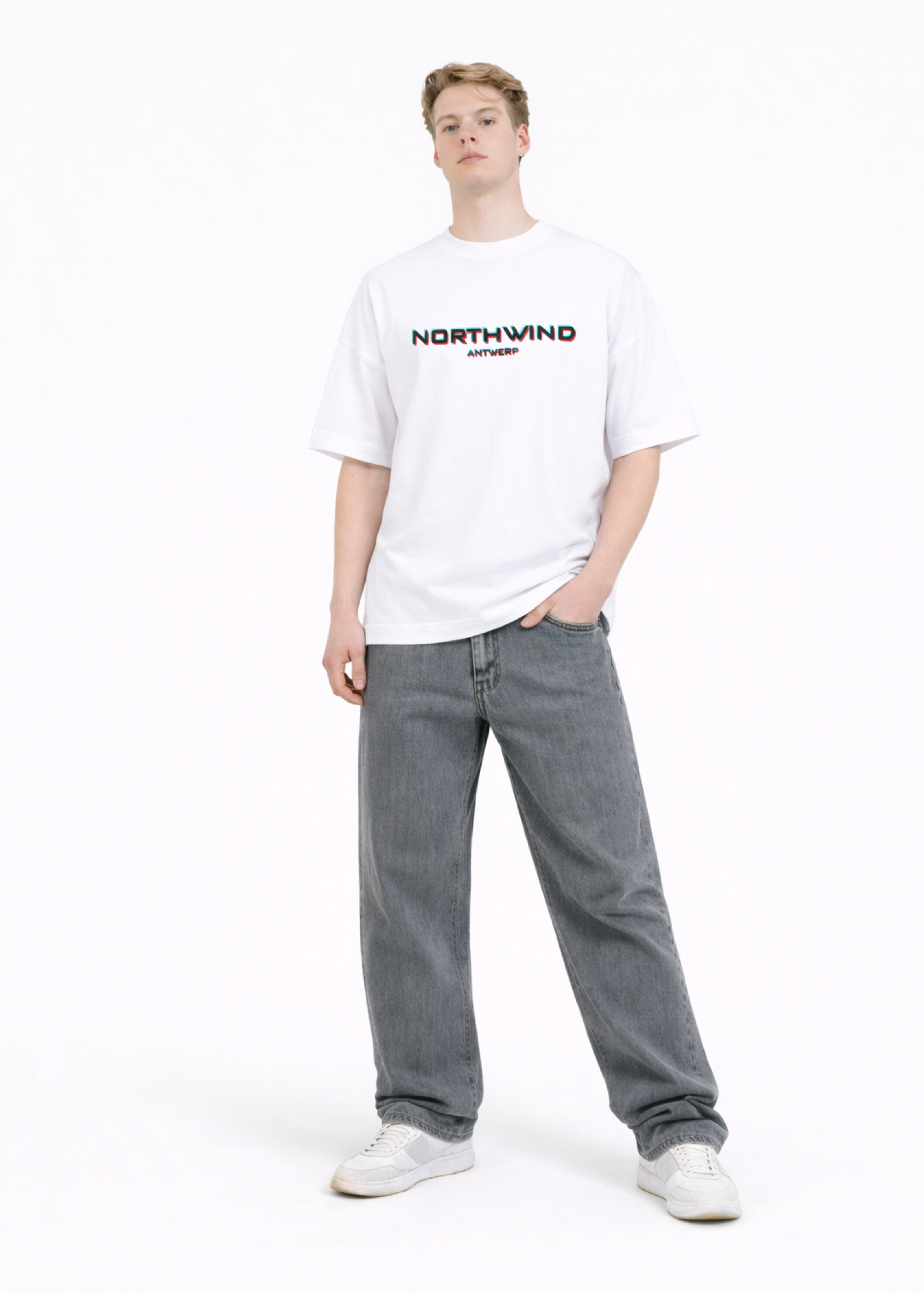 Person wearing a organic cotton oversized white t-shirt with glitch 'Northwind' logo and gray jeans on a white background