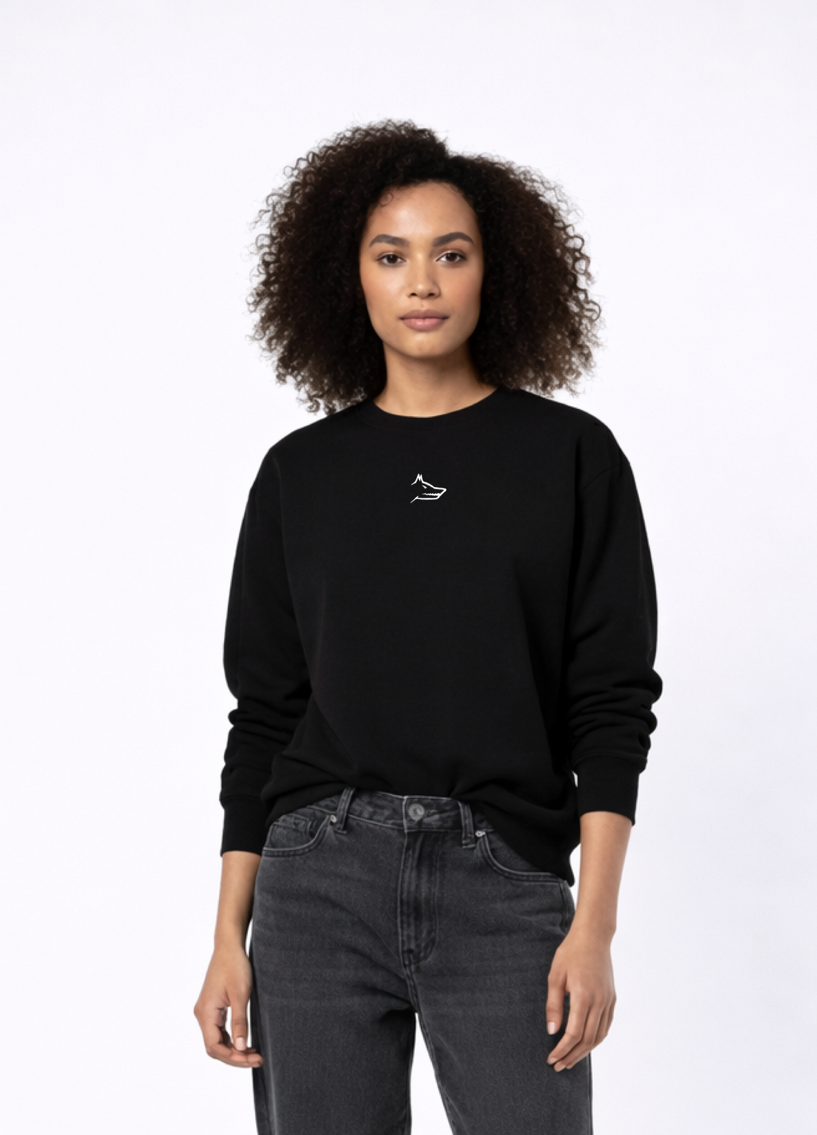 Woman wearing Northwind Lone Wolf black sweatshirt with minimalist wolf logo embroidered on the chest, gray levis jeans