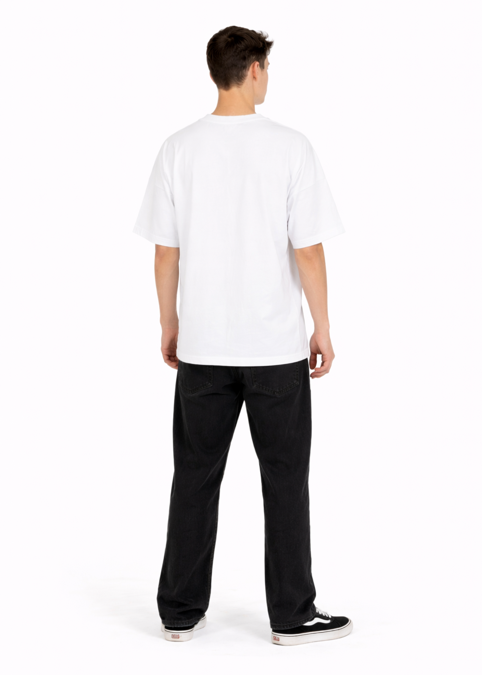 Young adult wearing a Northwind oversized organic cotton white t-shirt with Northwind embroidery on the chest, Carhartt pants, black Vans shoes