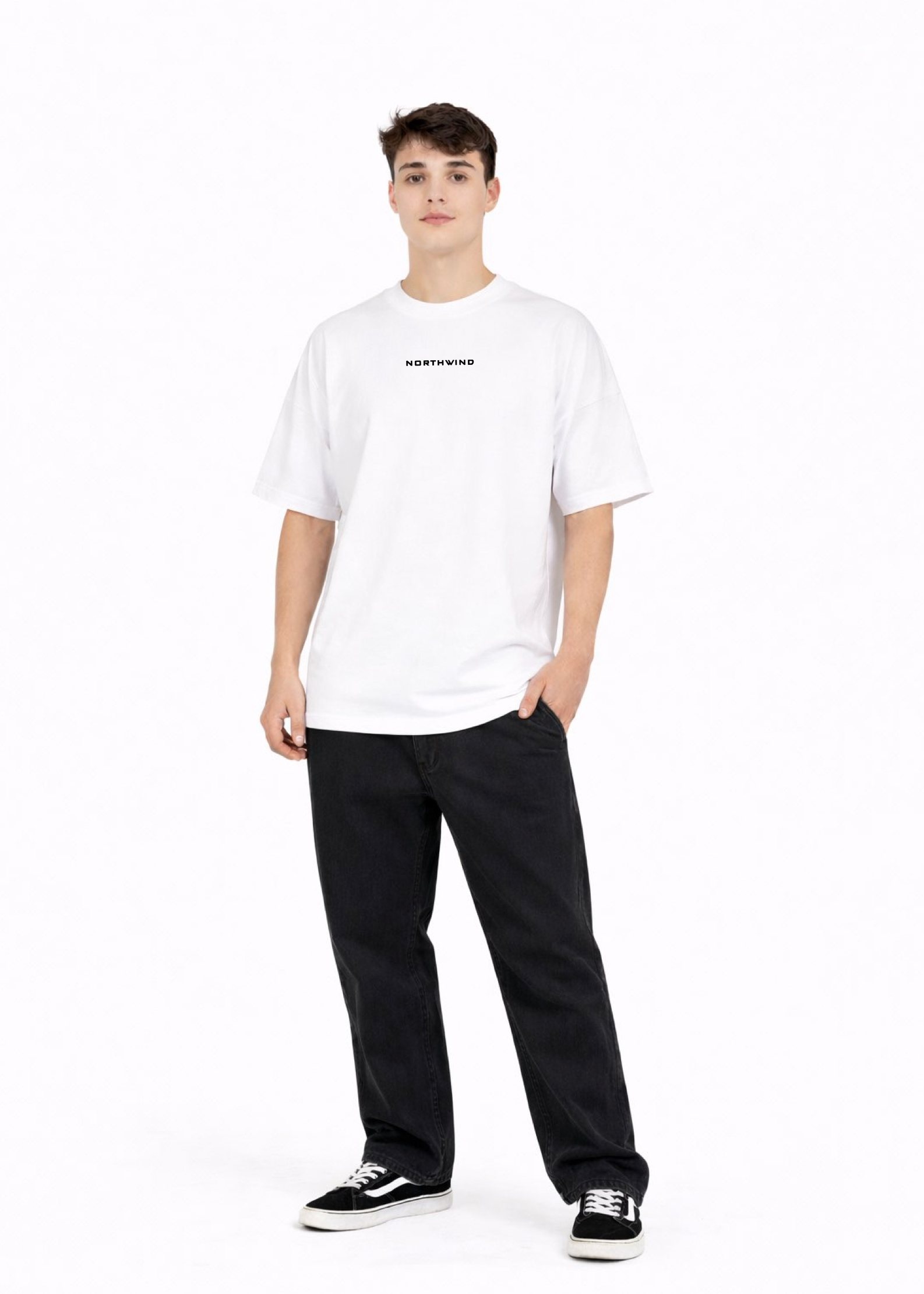 Young adult wearing a Northwind oversized organic cotton white t-shirt with Northwind embroidered on the chest, the waves design screen printed on the back, Carhartt pants, black Vans shoes