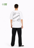 Young adult wearing a Northwind oversized organic cotton white t-shirt with Northwind embroidered on the chest, the waves design screen printed on the back, Carhartt pants, black Vans shoes