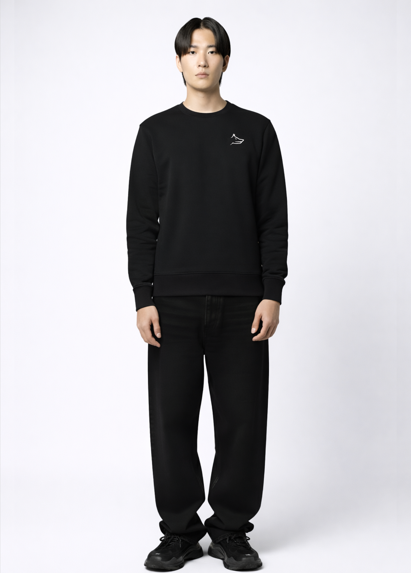 Asian model wearing a black Northwind sweatshirt with white Northwind embroidered wolf logo on the chest