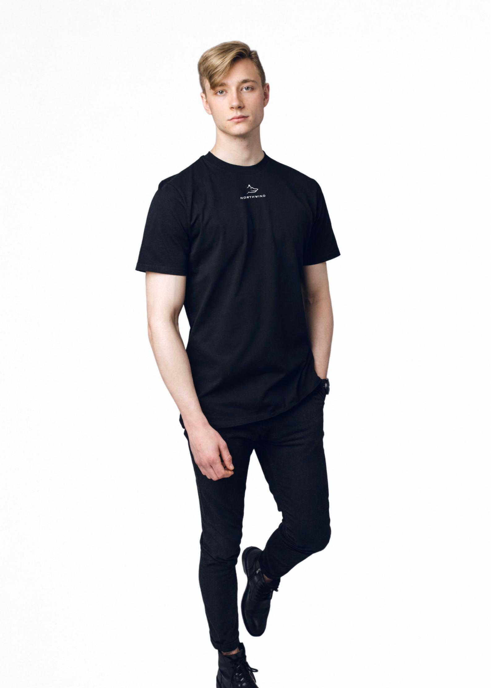 Blond man wearing a black Northwind casual t-shirt with minimalist Northwind embroidered wolf logo on the chest, black Casio watch