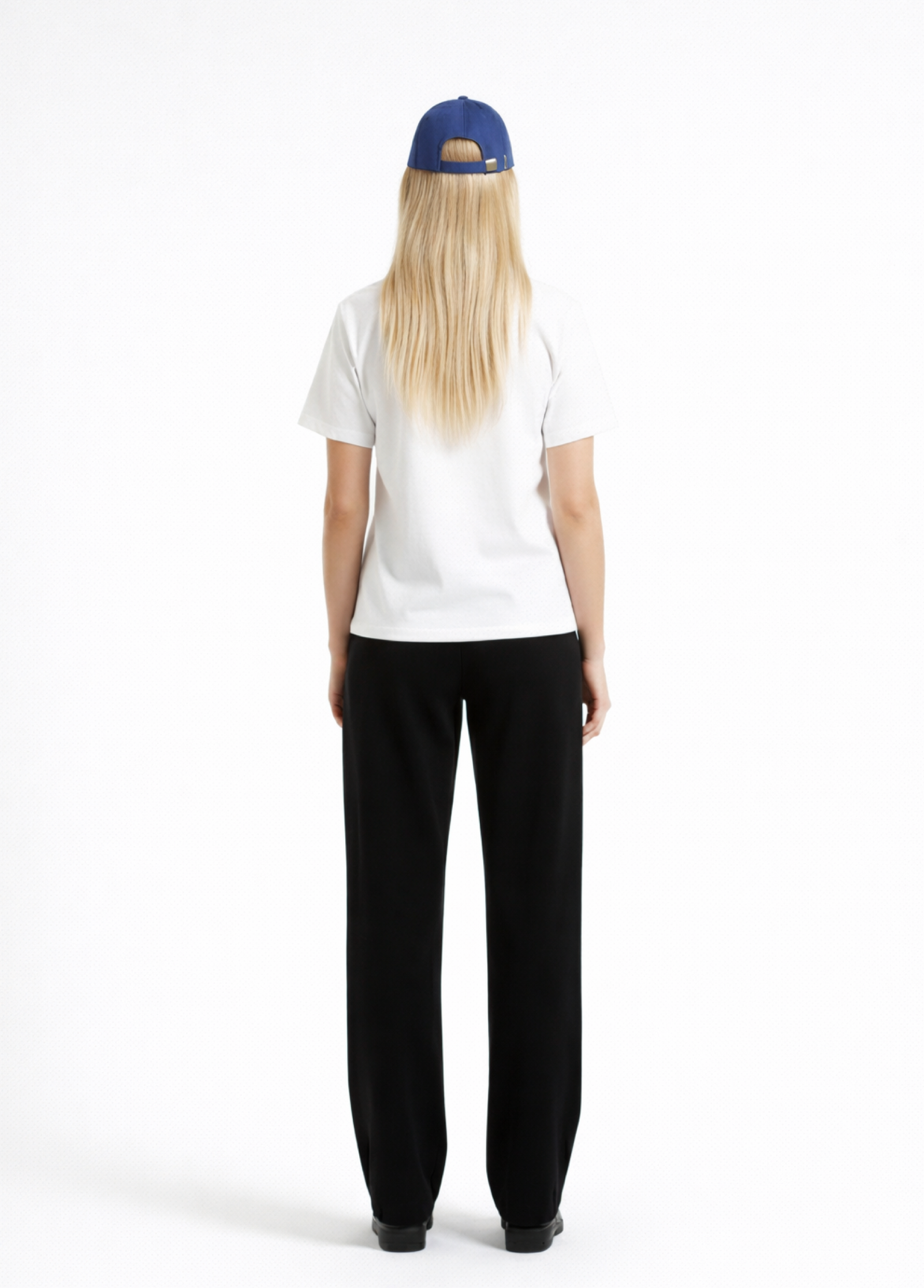 Woman wearing a white Northwind casual t-shirt , blue hat, black and black pants on a white background