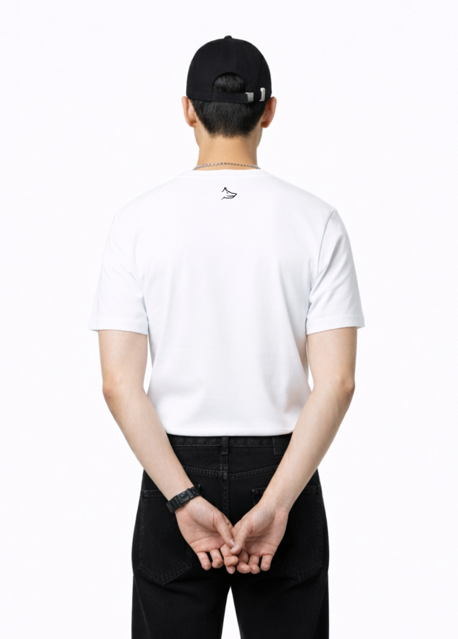 Man wearing an essential Northwind white t-shirt with minimalist Northwind embroidered wolf logo on the back, Carhartt black pants
