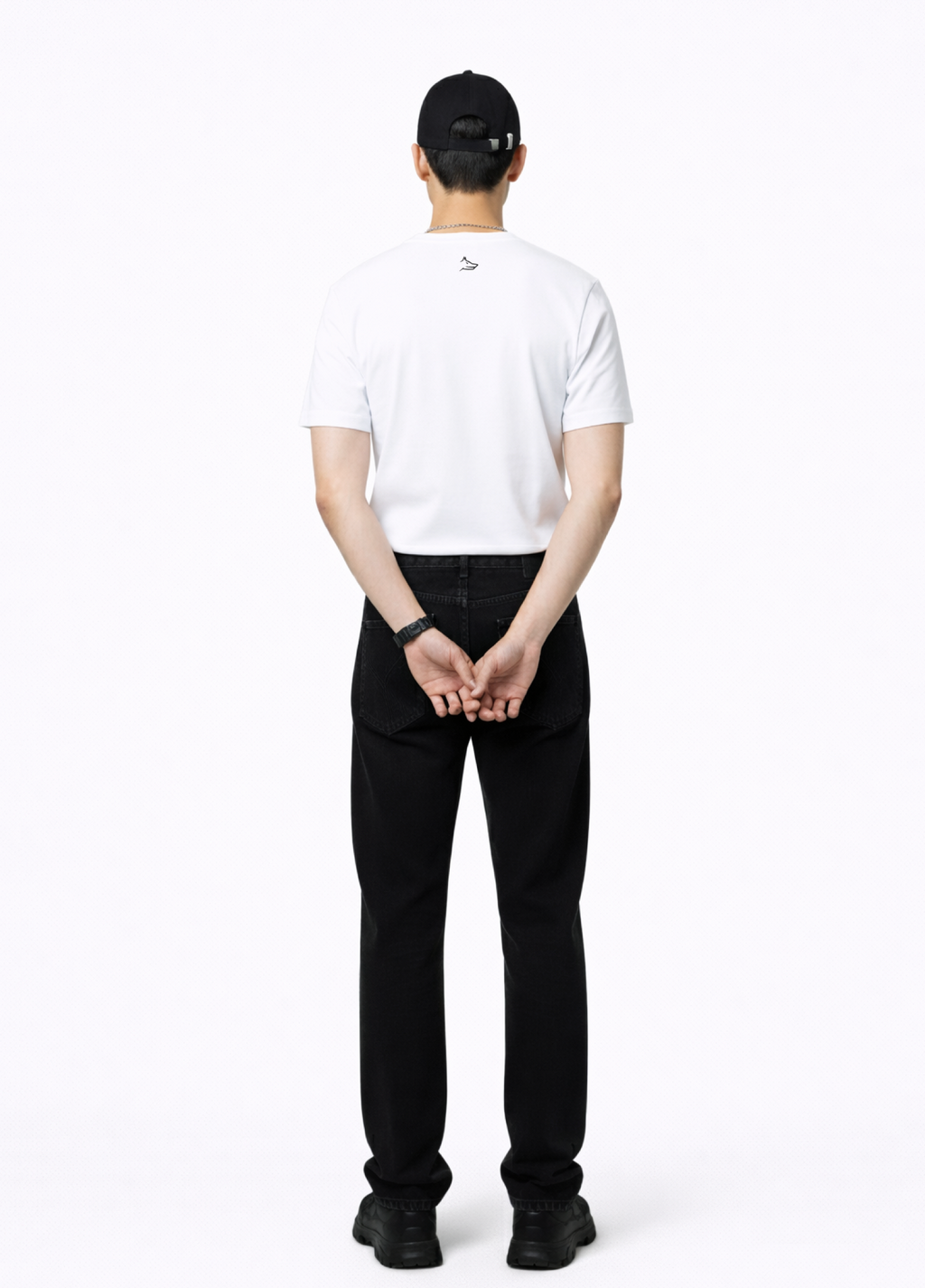 Man wearing a essential Northwind white t-shirt with minimalist Northwind embroidered wolf logo on the back, Dr. Martens boots, Carhartt black pants 