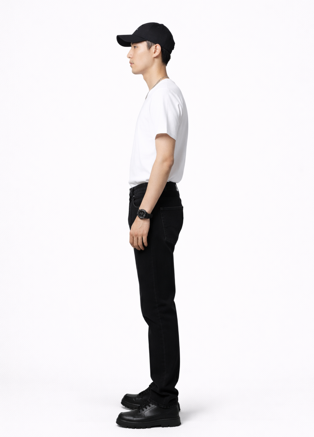 Man wearing an essential Northwind white t-shirt with minimalist Northwind embroidered wolf logo on the back, Dr. Martens boots, Carhartt black pants, black cap and Rolex watch