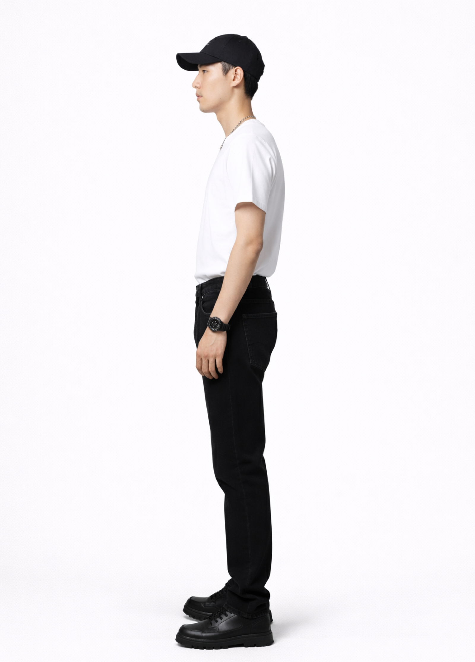 Man wearing an essential Northwind white t-shirt with minimalist Northwind embroidered wolf logo on the back, Dr. Martens boots, Carhartt black pants, black cap and Rolex watch