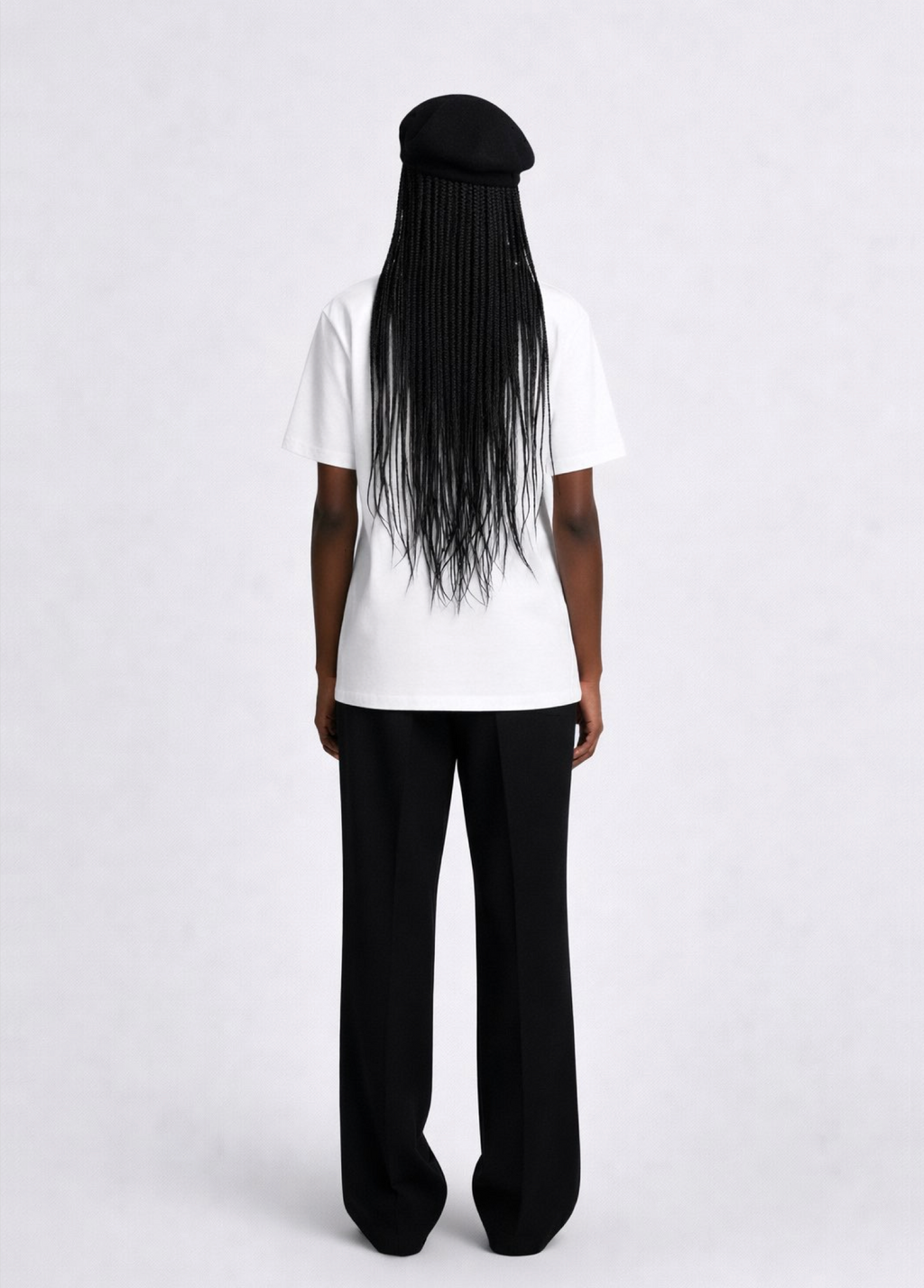 Black woman wearing a white essential Northwind t-shirt with embroidered logo on the chest, and black beret