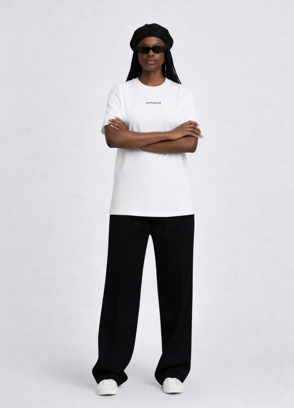 Black woman wearing a white essential Northwind t-shirt with embroidered logo, Gucci sunglasses, black beret and black pants