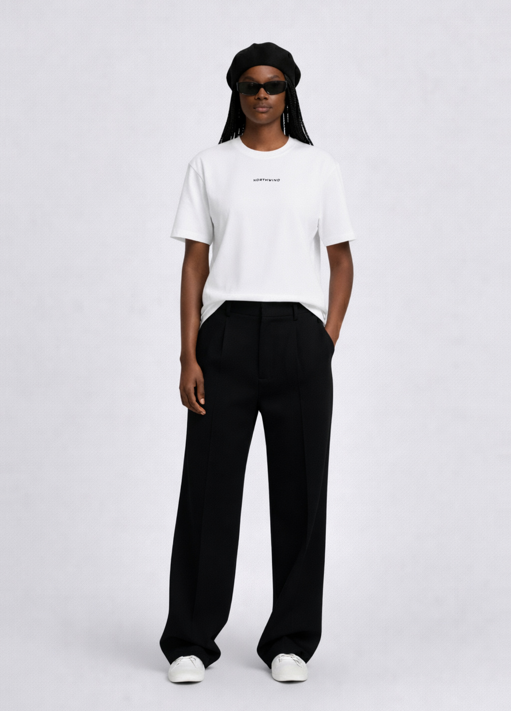 Black woman wearing a white essential Northwind t-shirt with embroidered logo, Gucci sunglasses, black beret and black pants