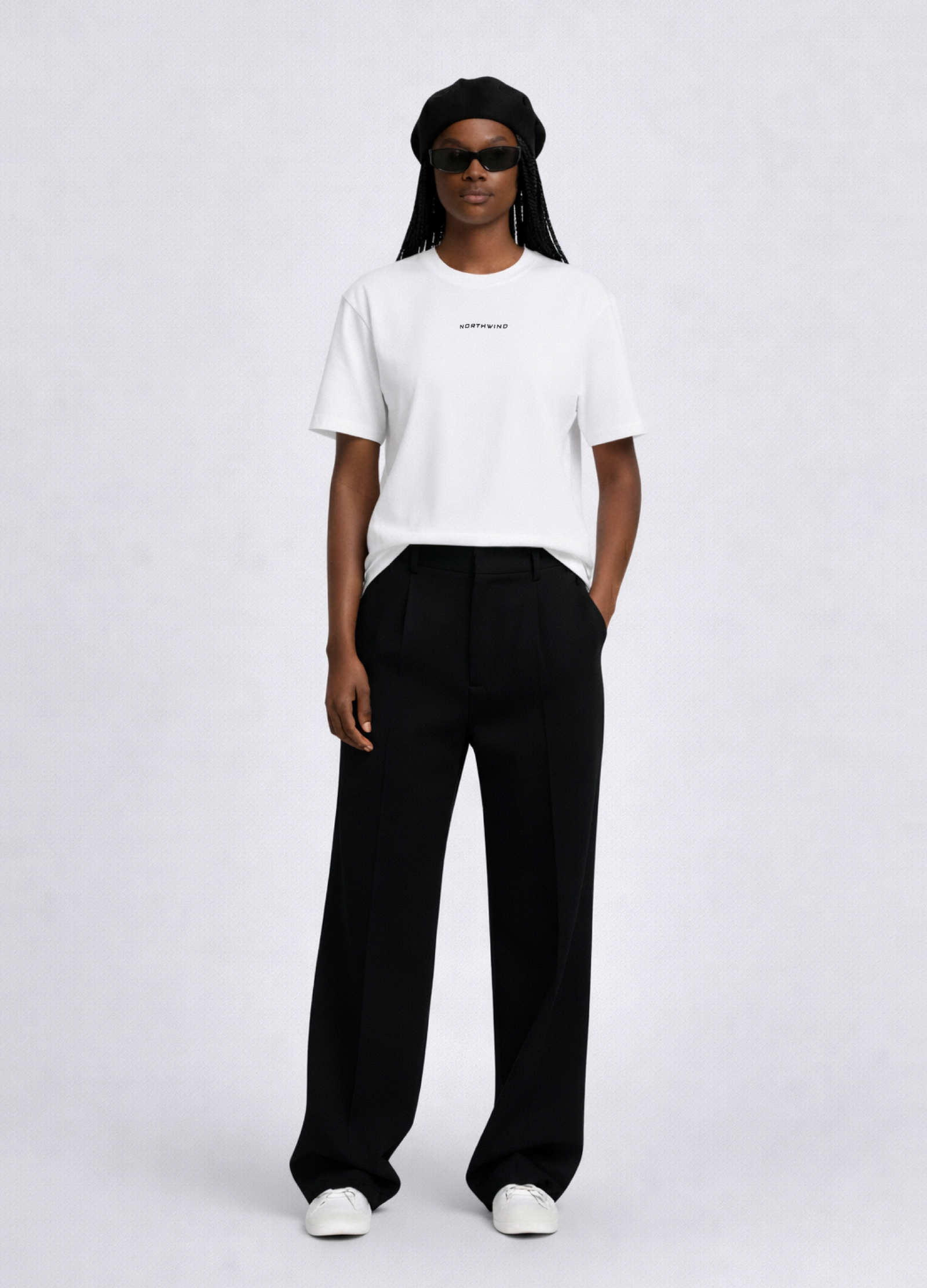Black woman wearing a white essential Northwind t-shirt with embroidered logo, Gucci sunglasses, black beret and black pants
