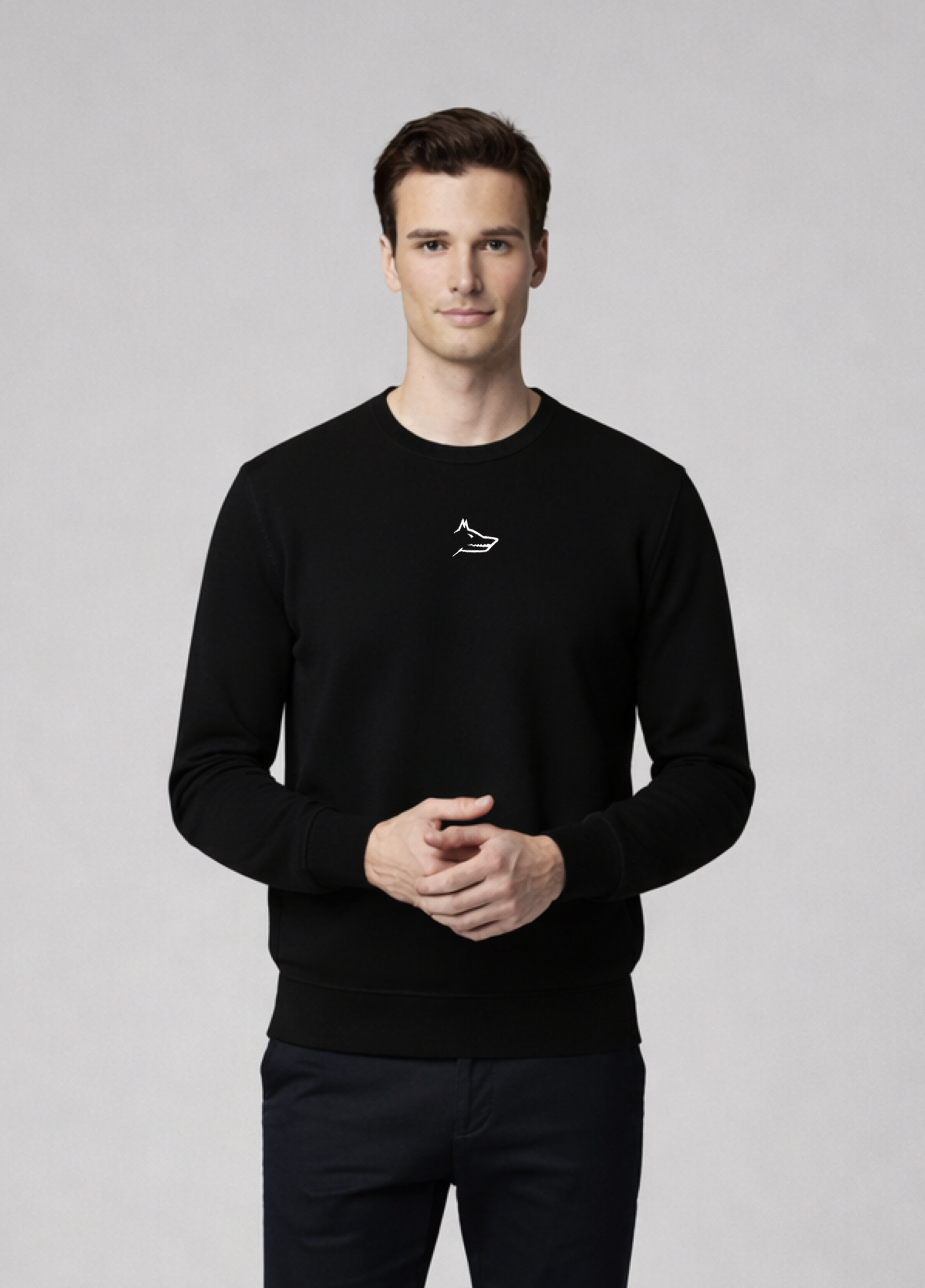 Man wearing a black Northwind sweater with white embroidered Northwind wolf logo on the chest