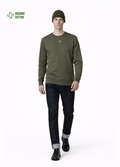 Man wearing a Northwind embroidered wolf logo khaki green sweatshirt and an olive green Northwind organic cotton beanie, and dark pants on a light gray background