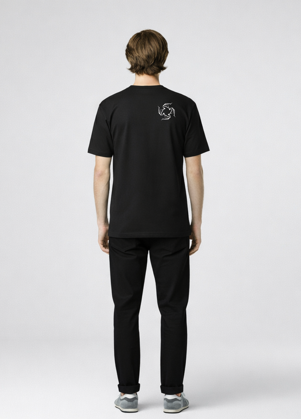 Man wearing a black Northwind storm of wolves t-shirt with embroidered Northwind storm of wolves logo on the back, gray New Balance shoes