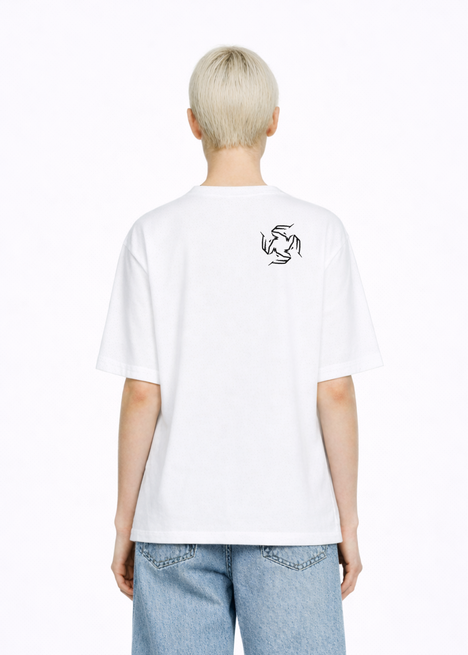 Blond, short hair girl wearing a white Northwind casual storm of wolves t-shirt with Northwind storm of wolves logo embroidered on the back, blue denim Carhartt oversized shorts