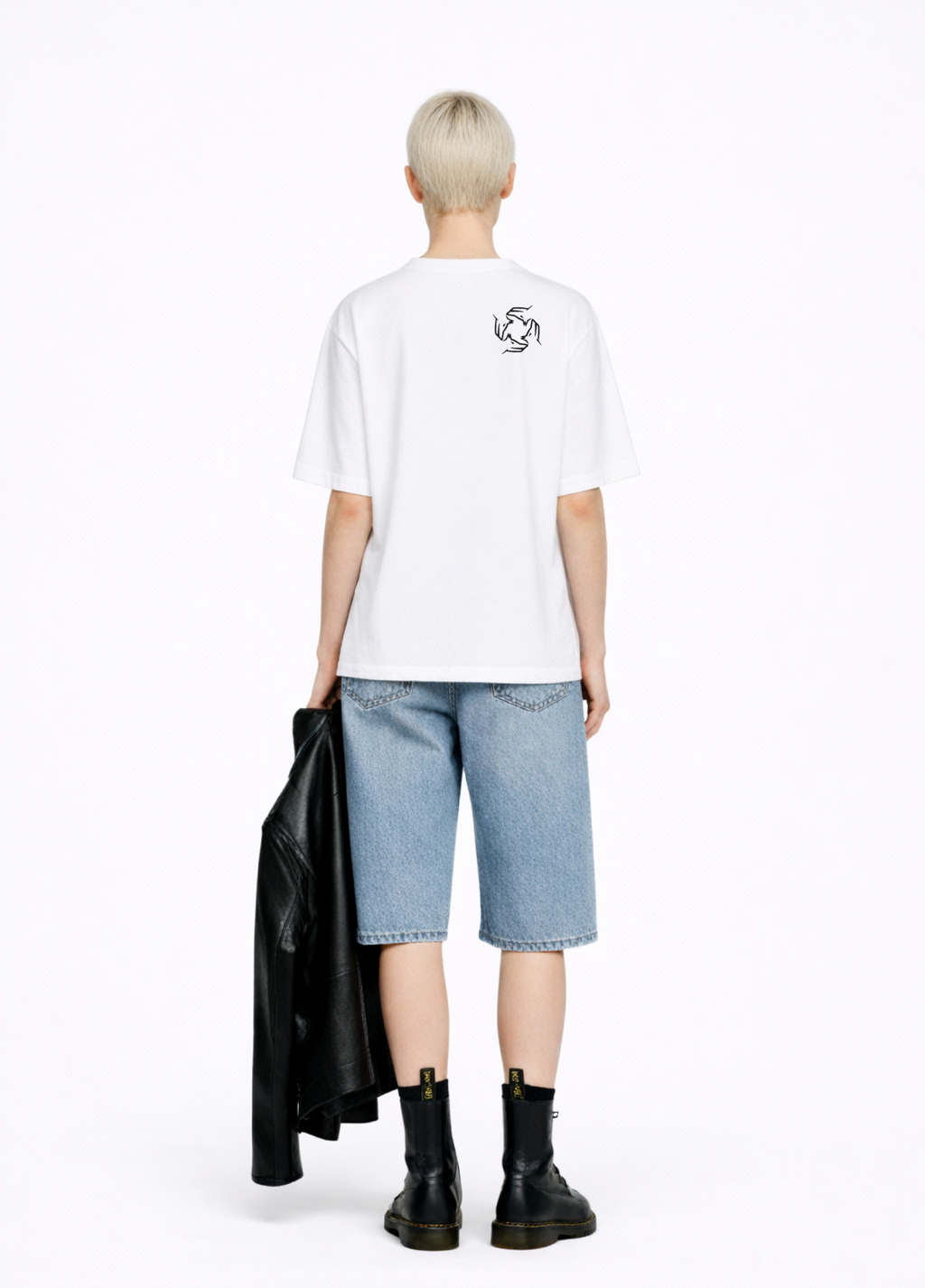 Blond, short hair girl wearing a white Northwind casual storm of wolves t-shirt with Northwind storm of wolves  embroidered logo on the back, blue denim Carhartt oversized shorts, black belt, and black Dr. Martens boots on a white background