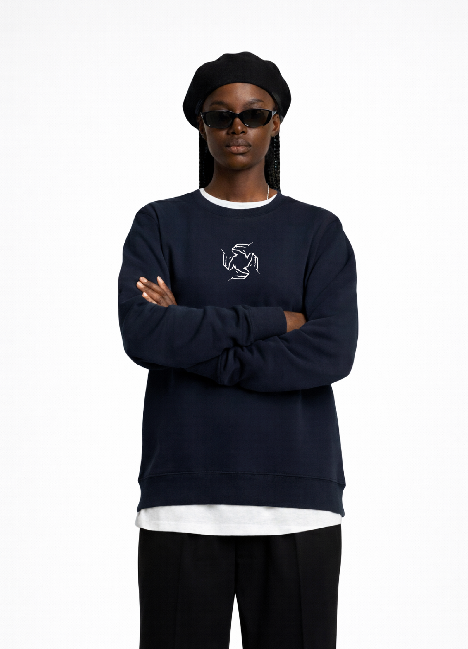 Black woman wearing a french navy blue Northwind sweatshirt with Northwind storm of wolves embroidered logo on the chest, black pants, and a black beret on a white background