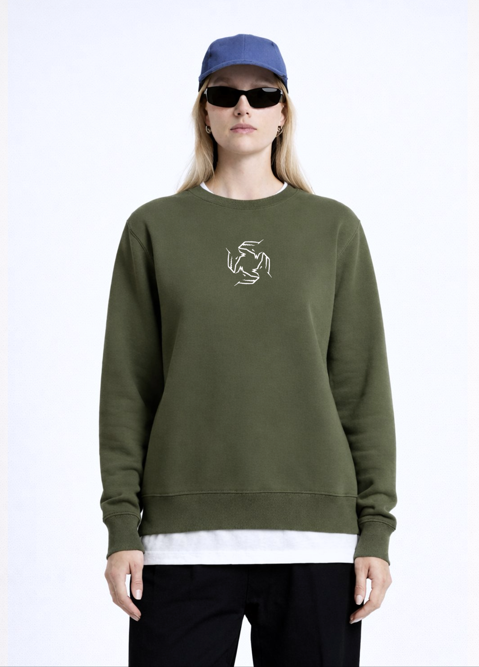 Woman wearing a khaki green Northwind sweatshirt with Northwind storm of wolves embroidered logo on the chest, black pants, and a black beret on a white background