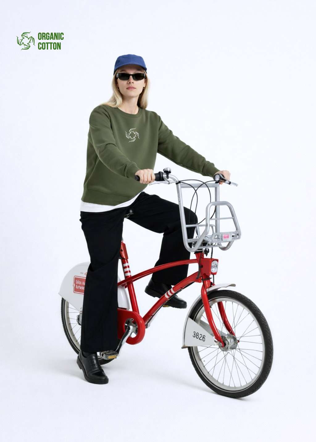 blond woman riding a red Antwerp city bicycle, wearing Northwind sweatshirt with storm of wolves embroidered logo on the chest