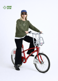 blond woman riding a red Antwerp city bicycle, wearing Northwind sweatshirt with storm of wolves embroidered logo on the chest