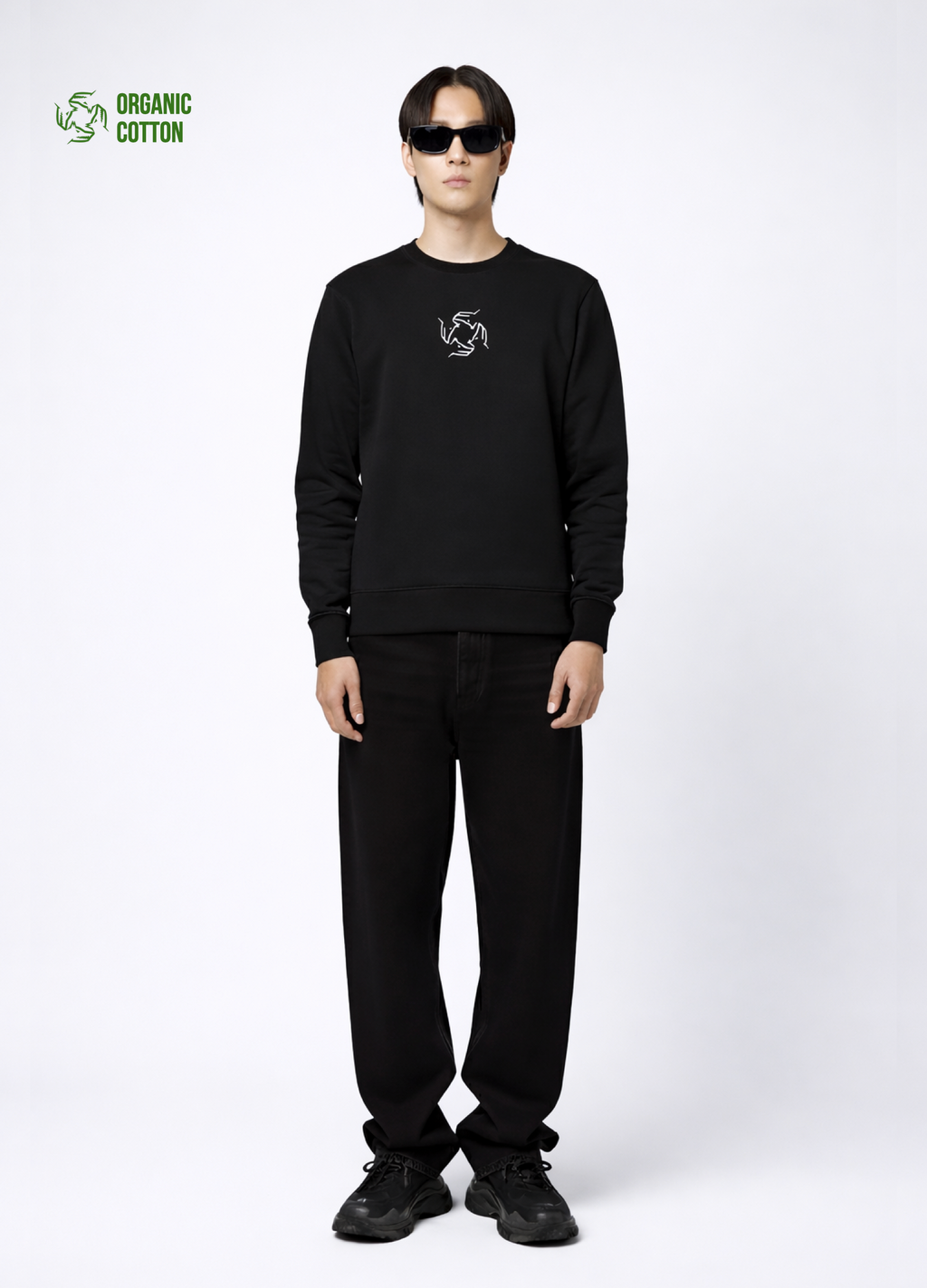 Person wearing a black Northwind sweatshirt with Northwind wolf storm logo and black Balenciaga sport shoes
