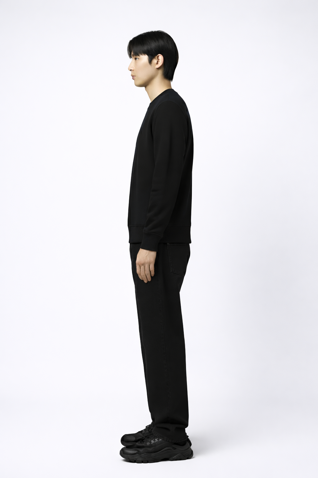 An asian man wearing a black Northwind sweatshirt with Northwind wolf storm logo on a white background side look