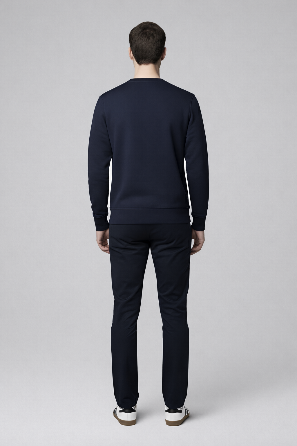 Man wearing a french navy Northwind sweatshirt on a white background, back pose
