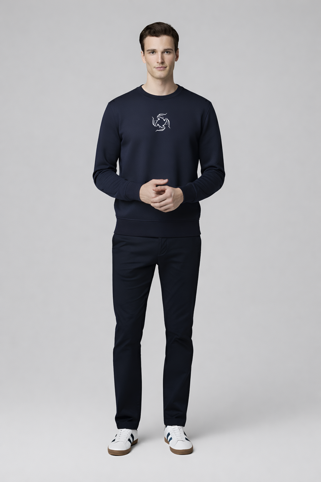 Man wearing a french navy Northwind sweatshirt with Northwind wolf storm embroidered logo on a white background, front pose