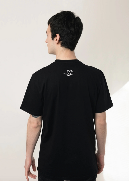 wearing a black Northwind Wolfinity t-shirt with a white Northwind wolfinity logo on the back