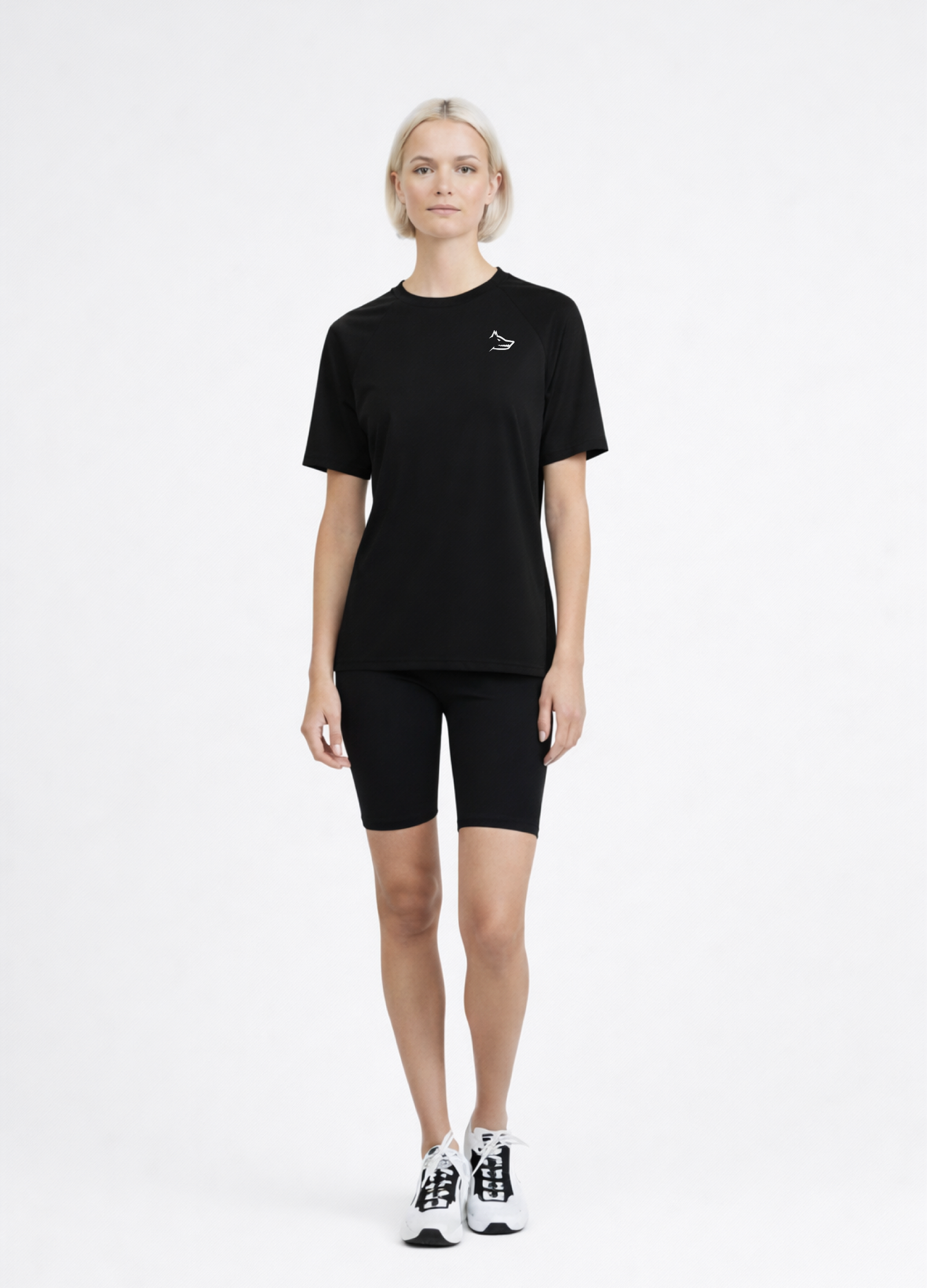 Woman wearing a black Northwind activewear t-shirt with Northwind wolf logo on the chest, black shorts and ON performance running shoes