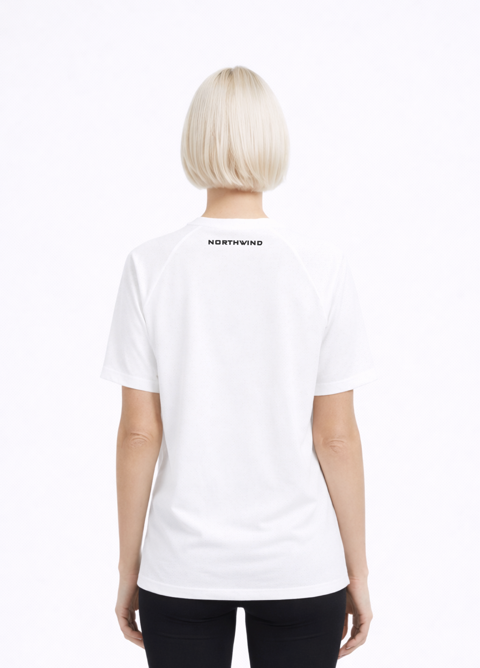 Woman wearing a white Northwind activewear t-shirt with Northwind on the back against a white background