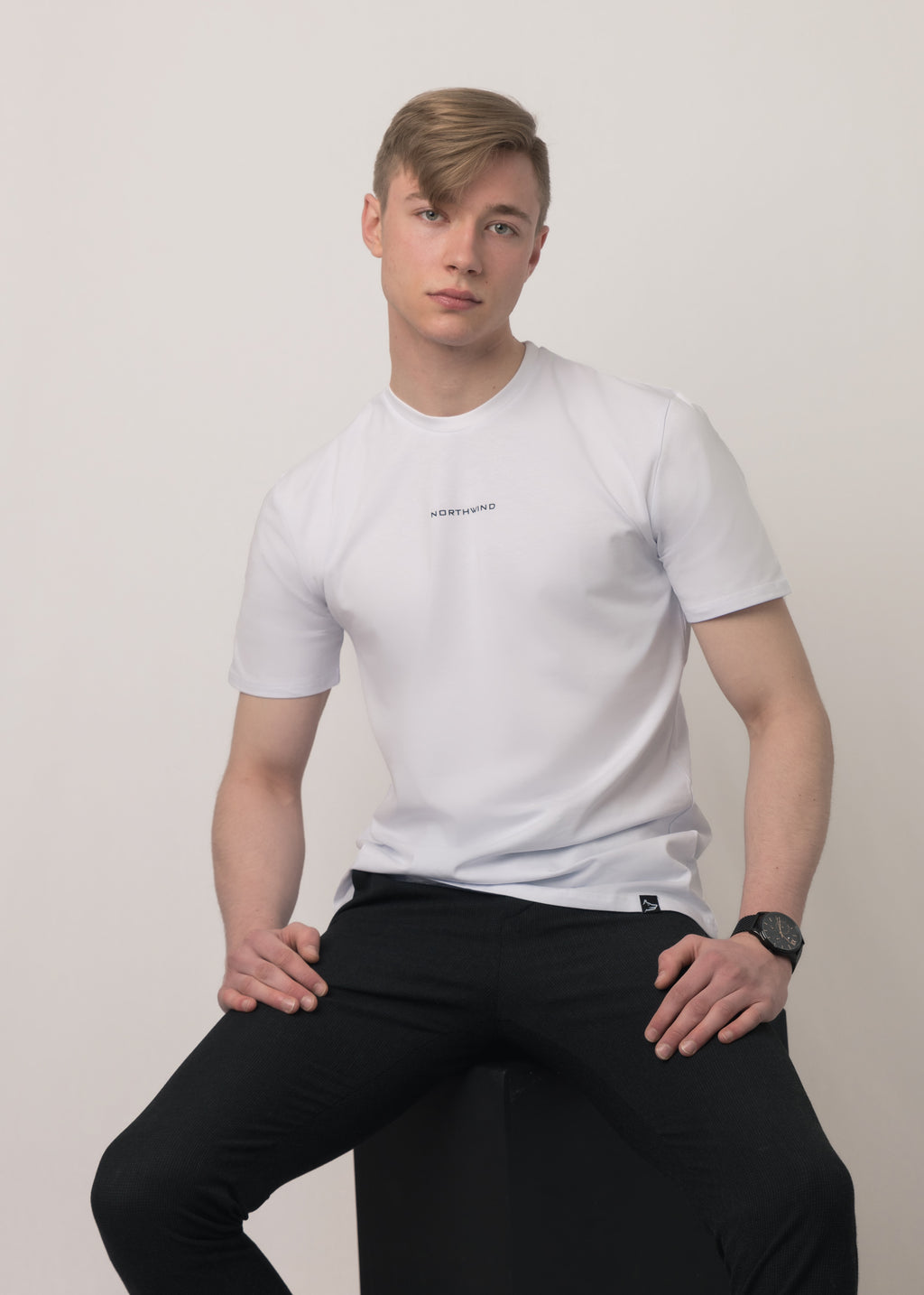 Man sitting and wearing a white Northwind slim fit t-shirt 