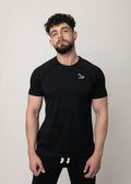 A male model wearing a black short-sleeved activewear t-shirt with a minimalist Northwind wolf logo on the chest.